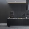 Image of a kitchen with cabinets made with Thermally Fused Laminate in color Black and PET Laminates in Noir in Matt finish by Duramar.