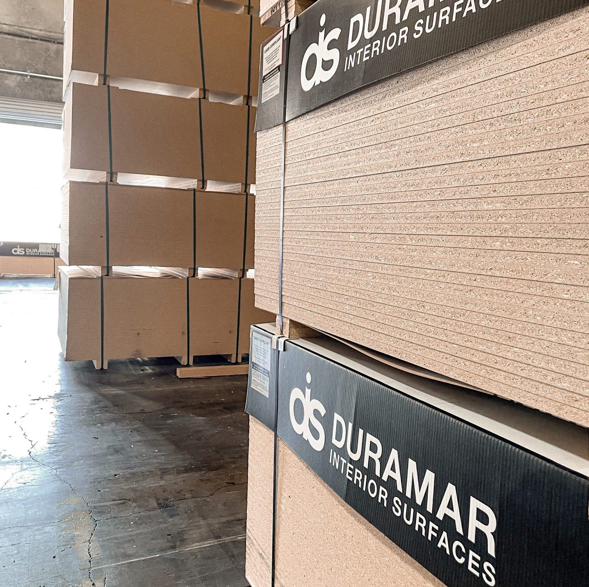 Duramar Interior Surfaces Warehouse Hallway with finished product stacked.